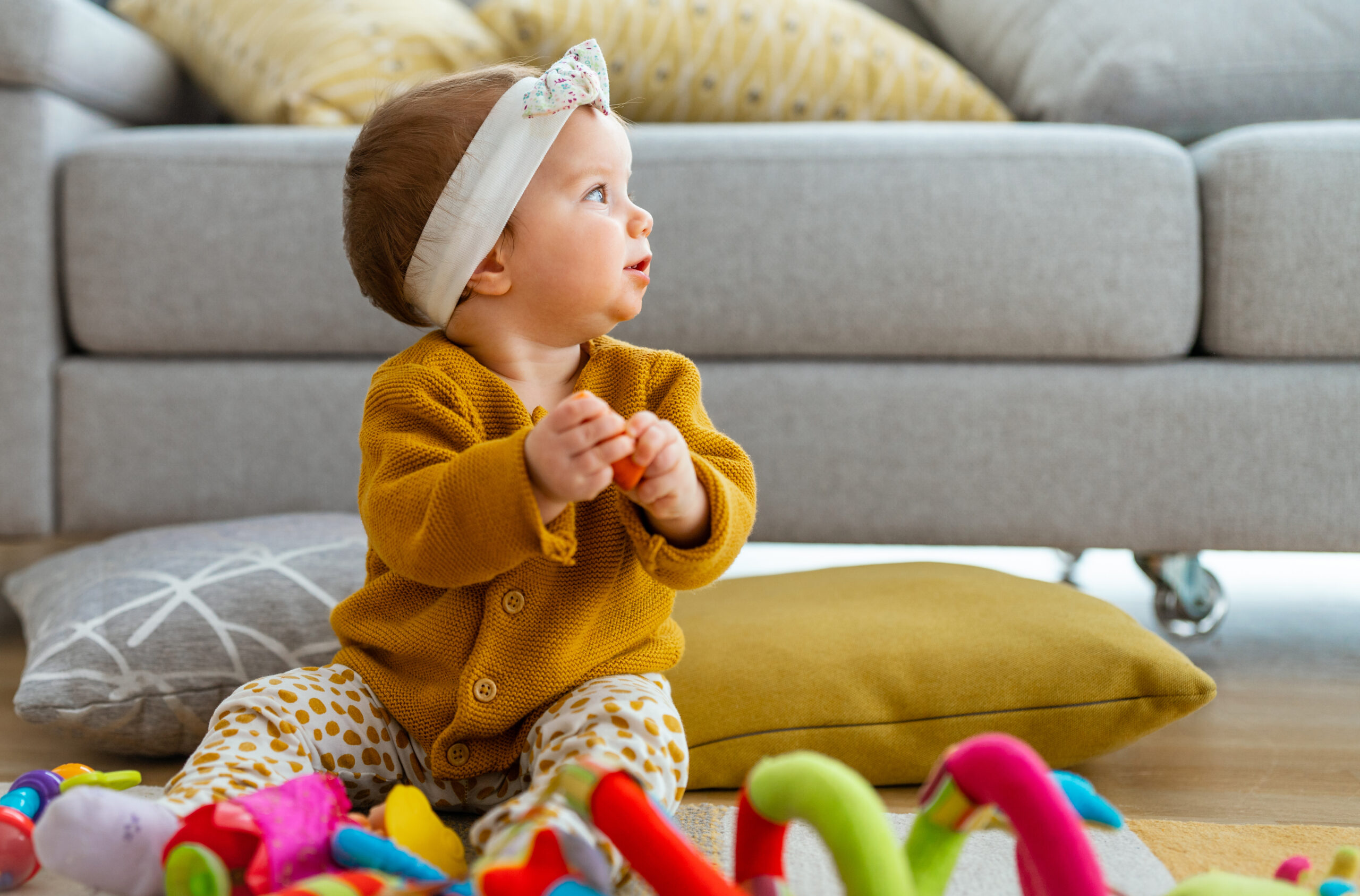 Adorable baby playing with colorful toy at home Cute baby playing with colorful toy at home